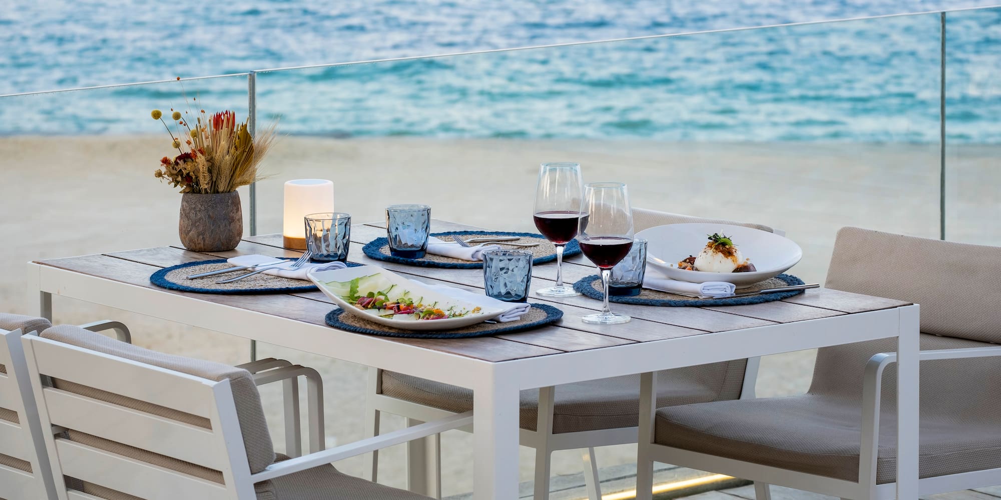 a table with plates and glasses of wine on it