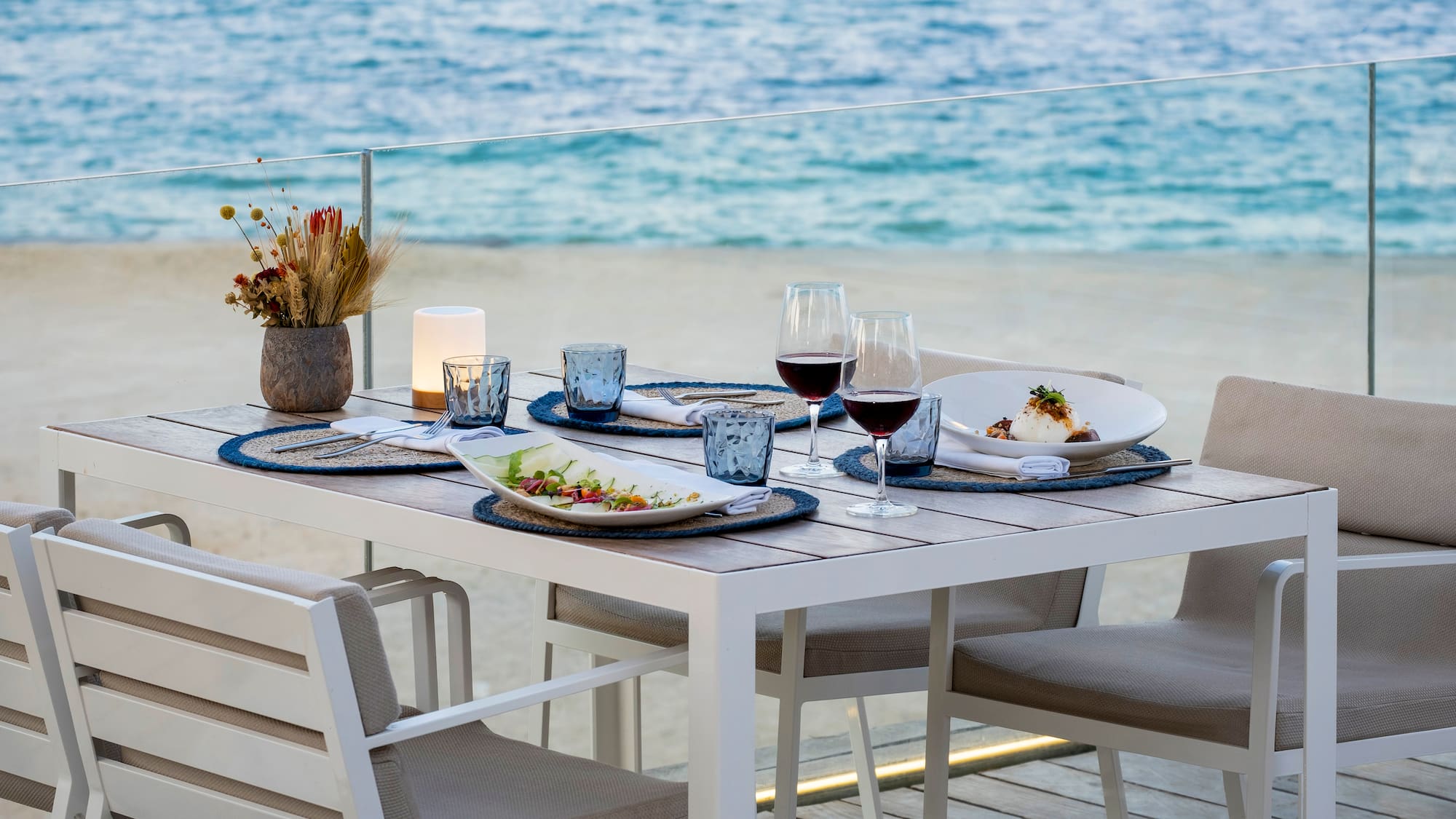 a table with plates and glasses of wine on it