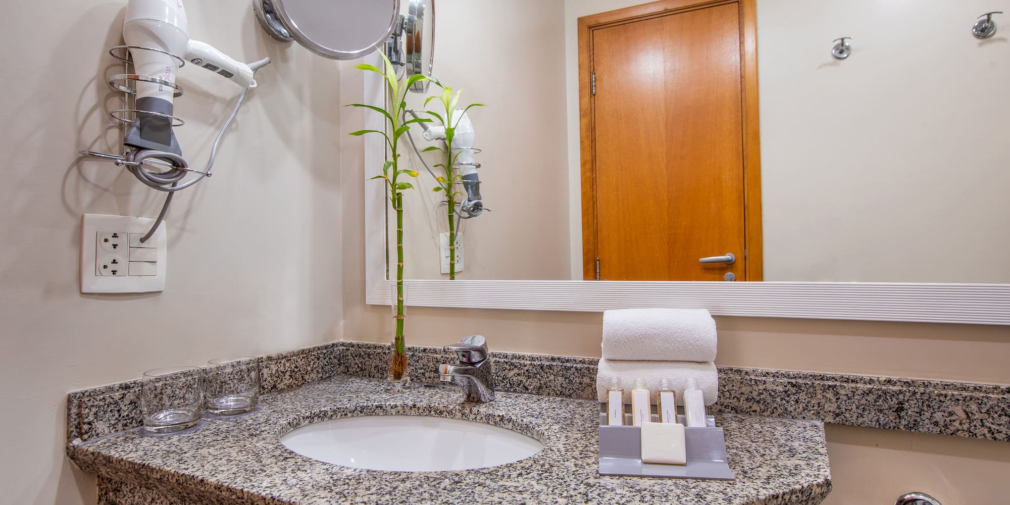 a bathroom with a mirror and a sink