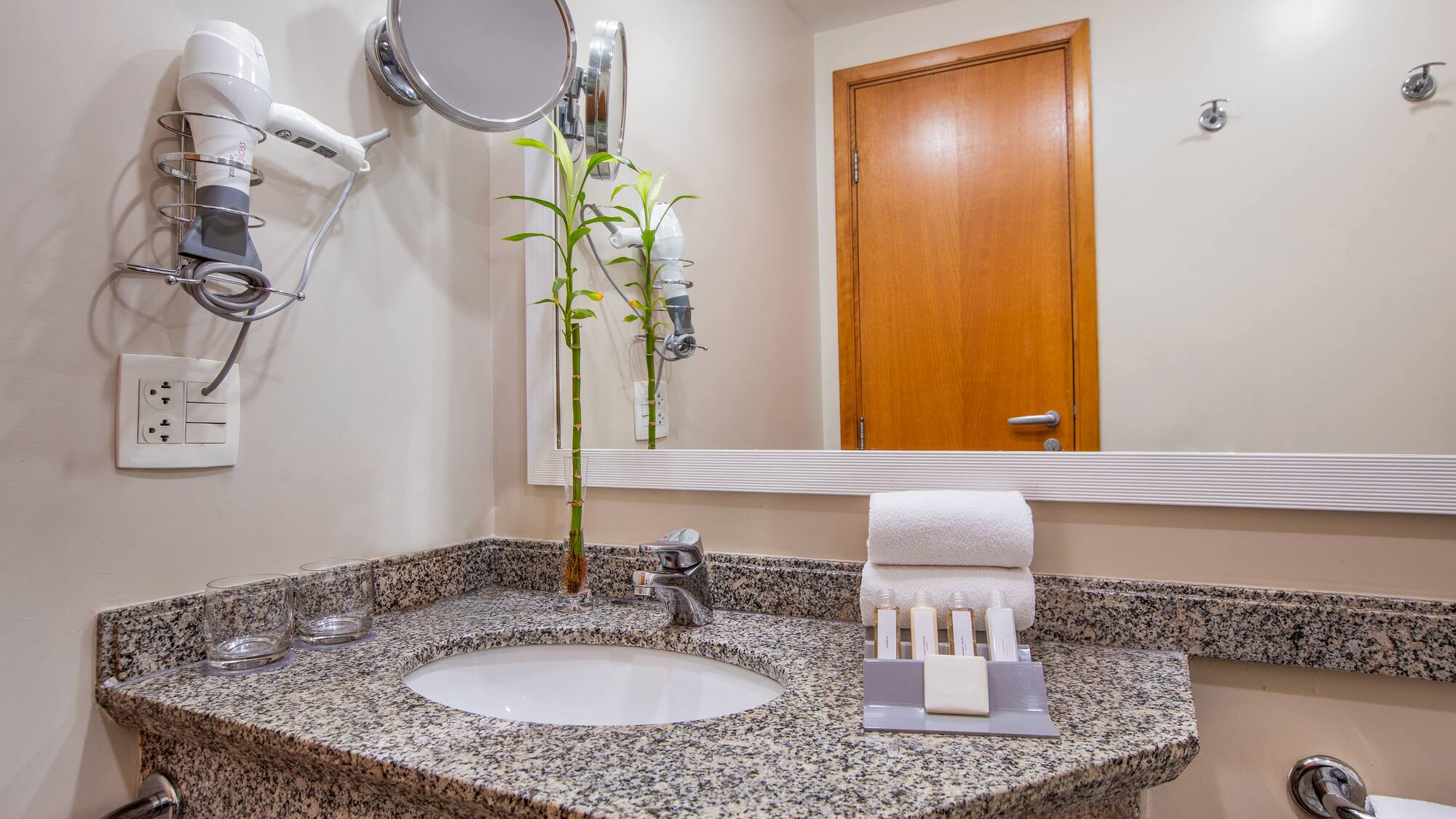 a bathroom with a mirror and a sink