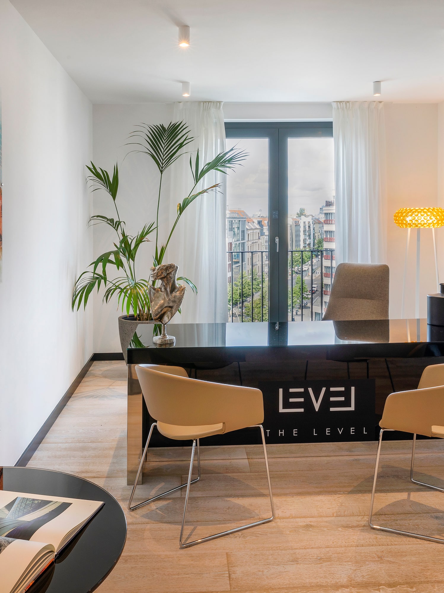 a room with a desk and chairs