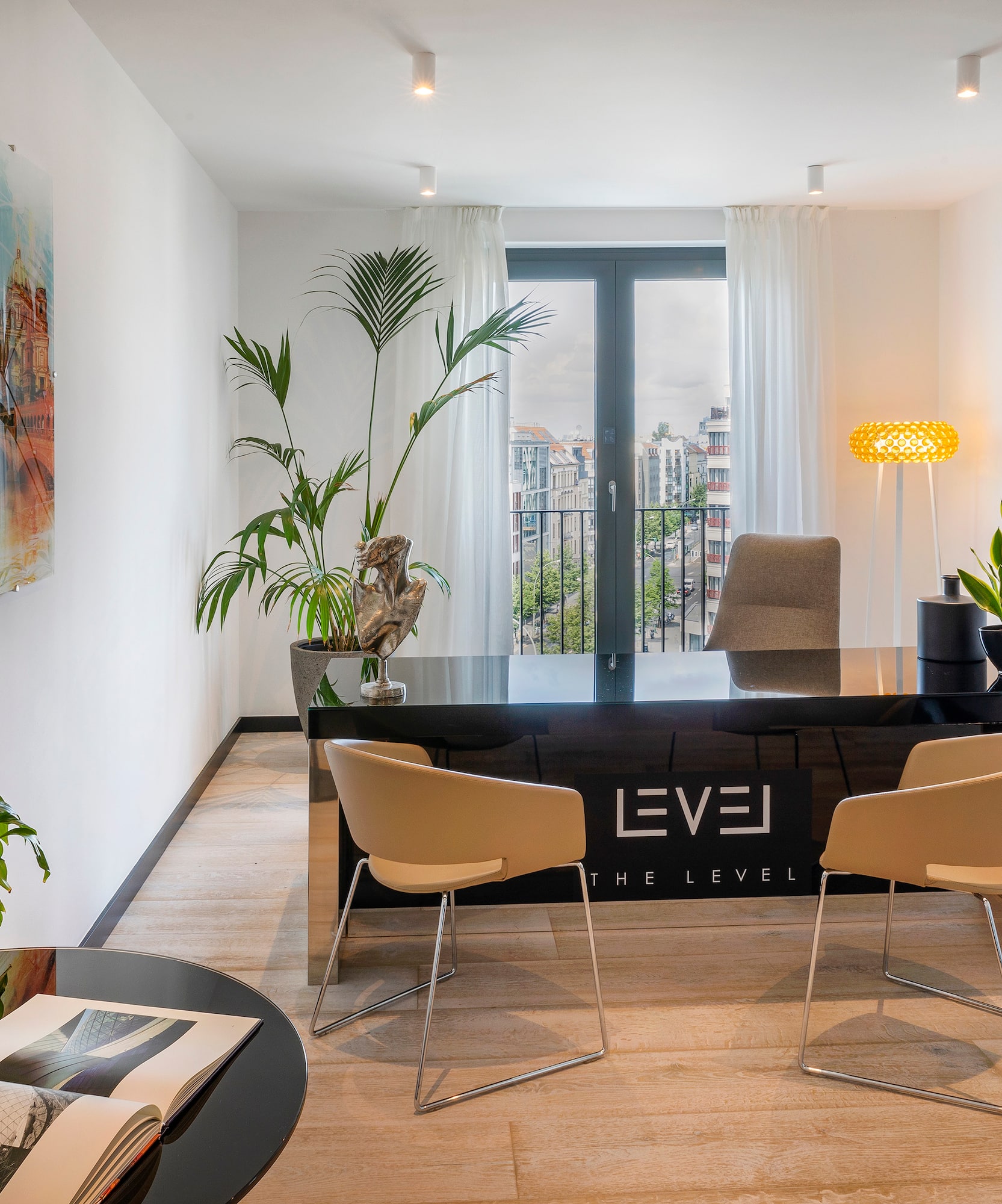 a room with a desk and chairs