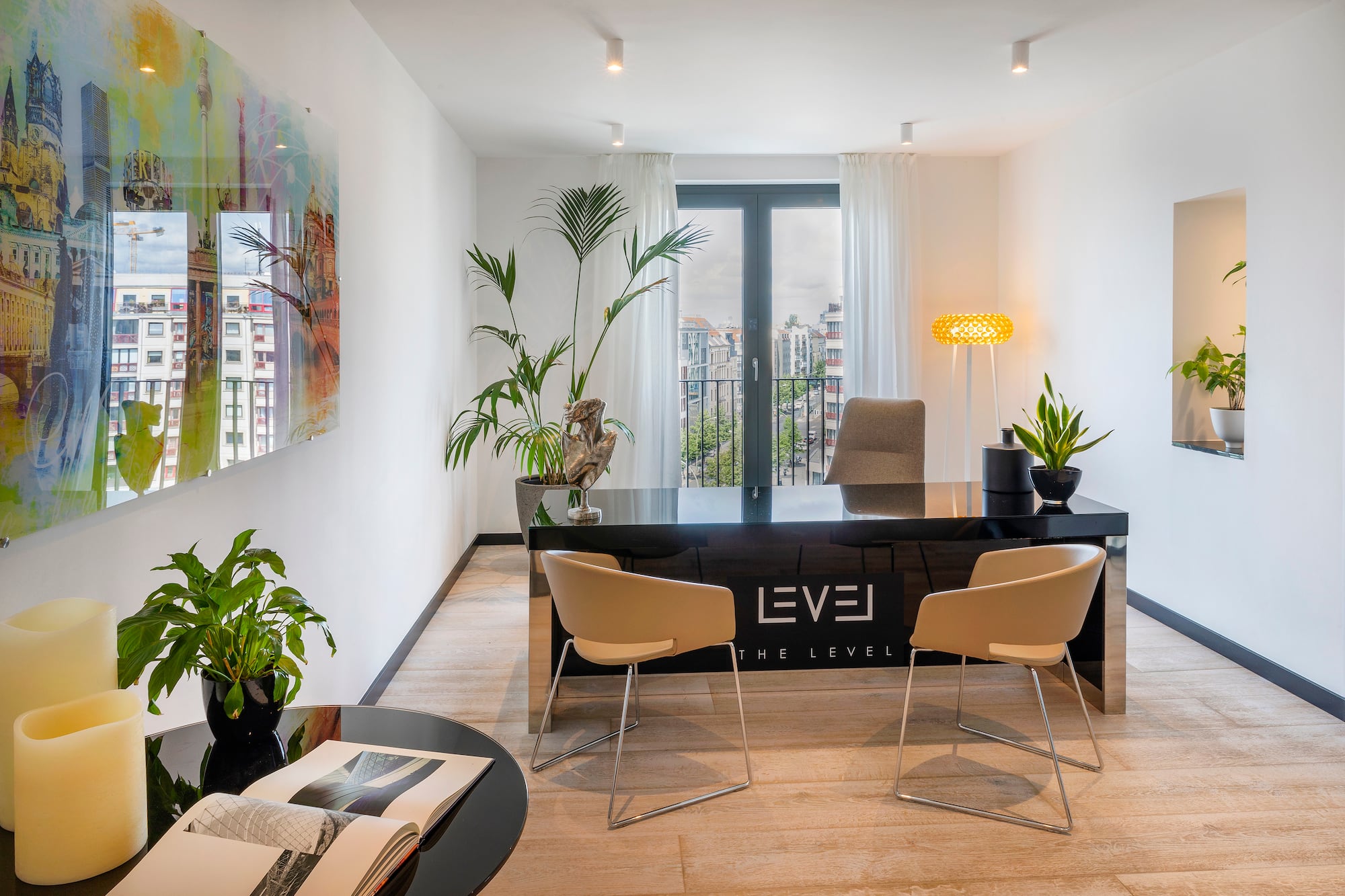 a room with a desk and chairs