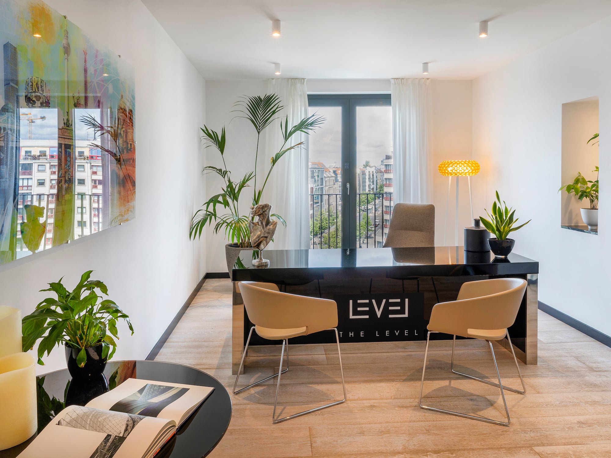 a room with a desk and chairs