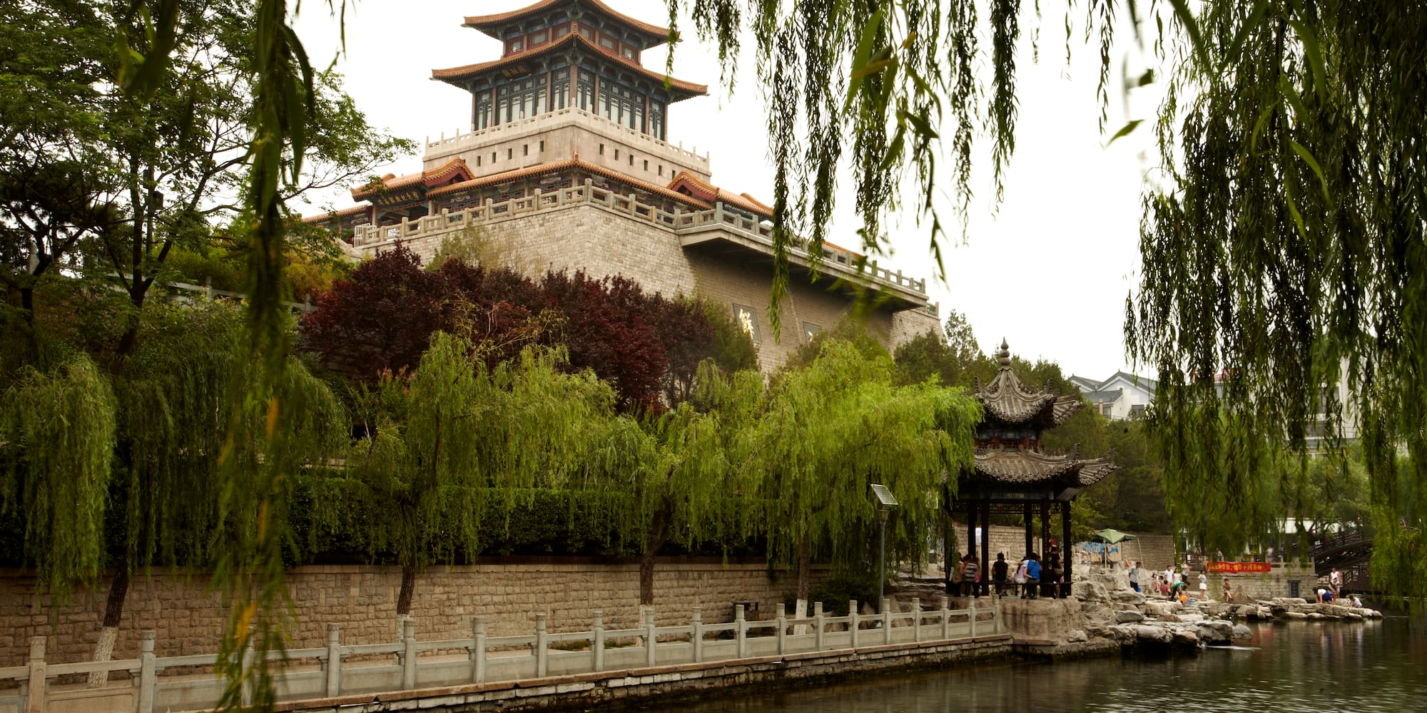 a building with a pagoda and a body of water
