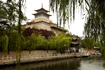 a building with a pagoda and a body of water