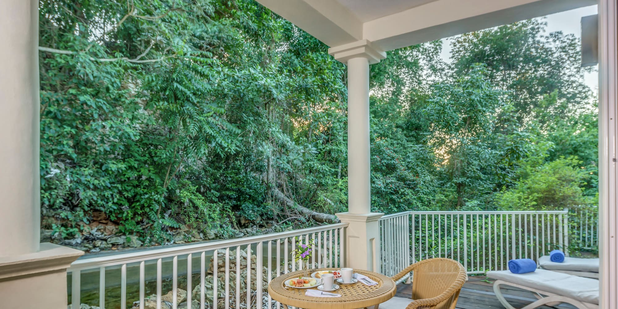 a patio with a table and chairs and a chair on a deck