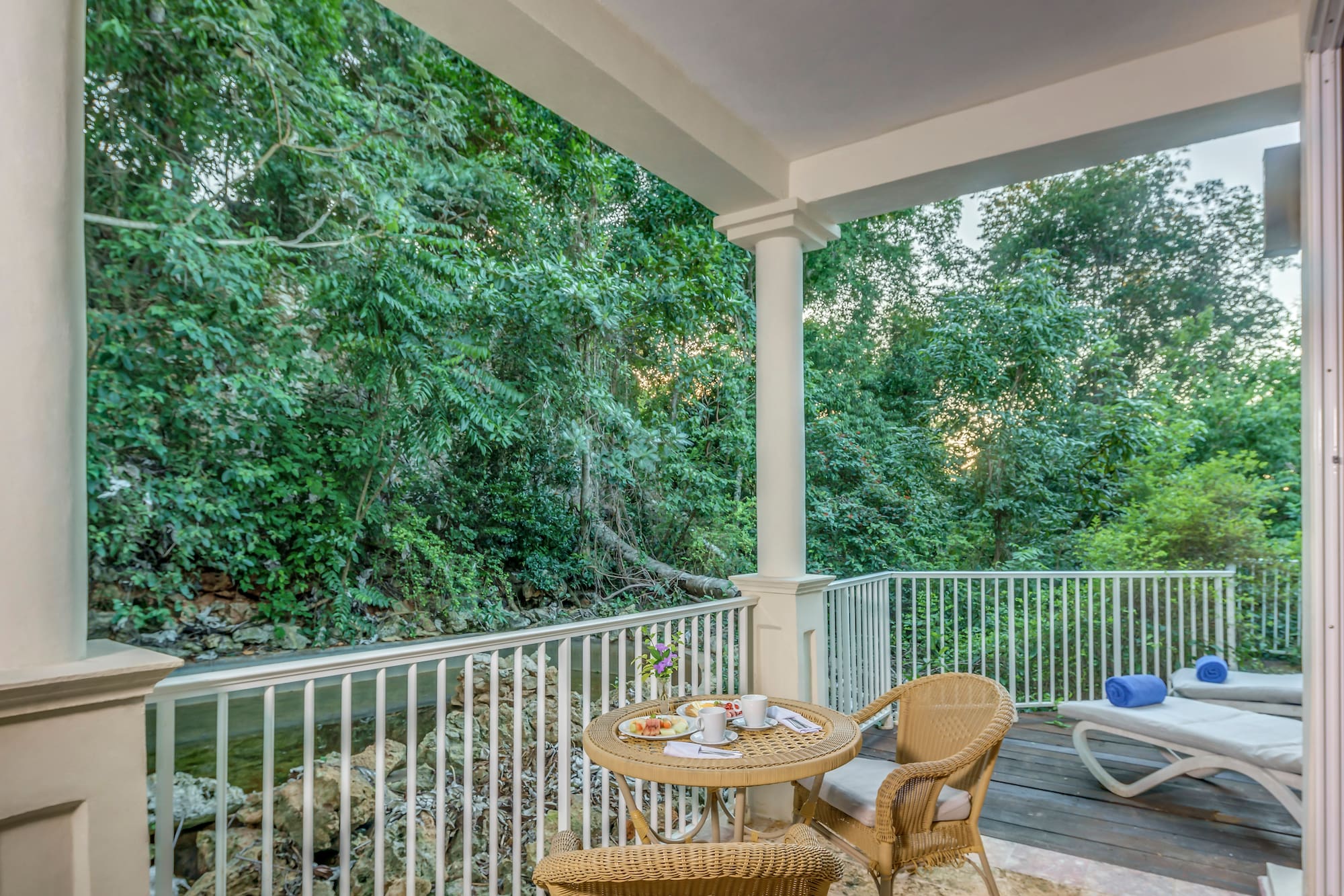 a patio with a table and chairs and a chair on a deck