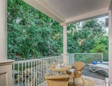 a patio with a table and chairs and a chair on a deck