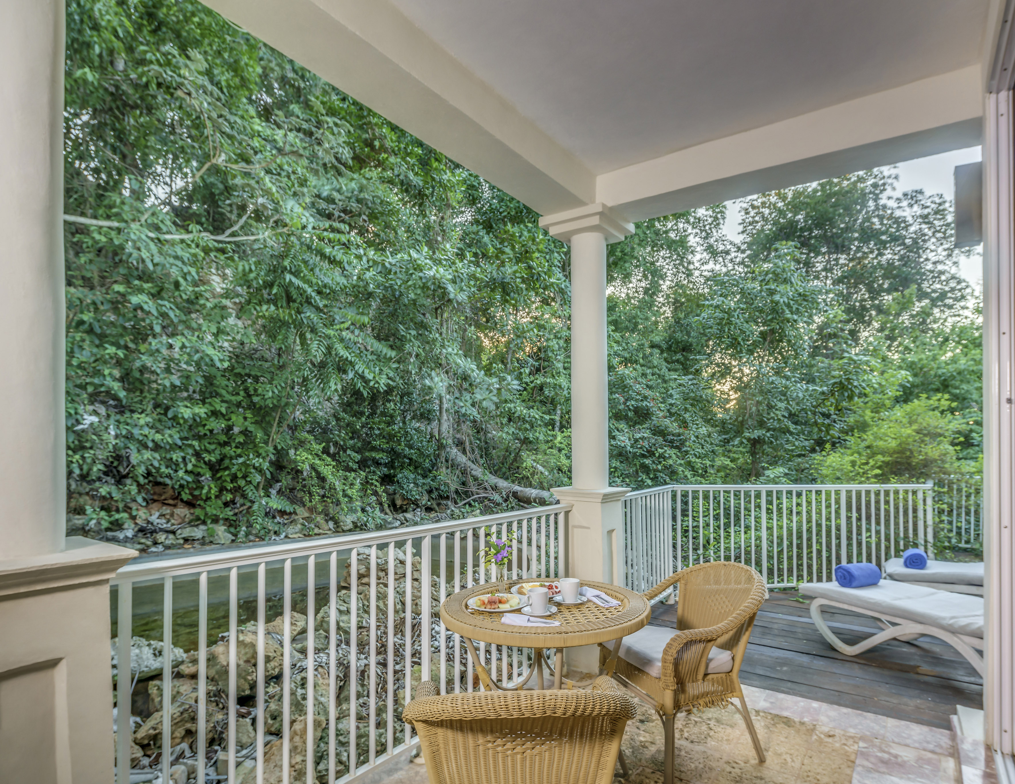 a patio with a table and chairs and a chair on a deck