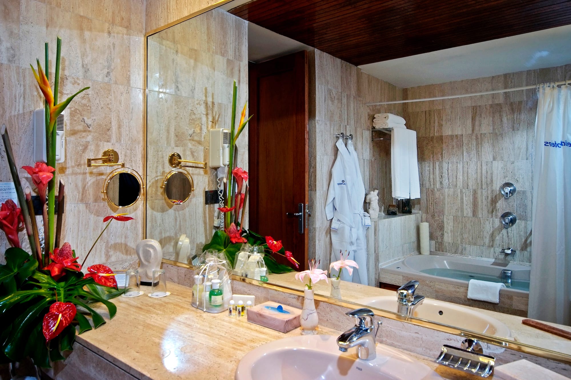a bathroom with a large mirror and a bathtub