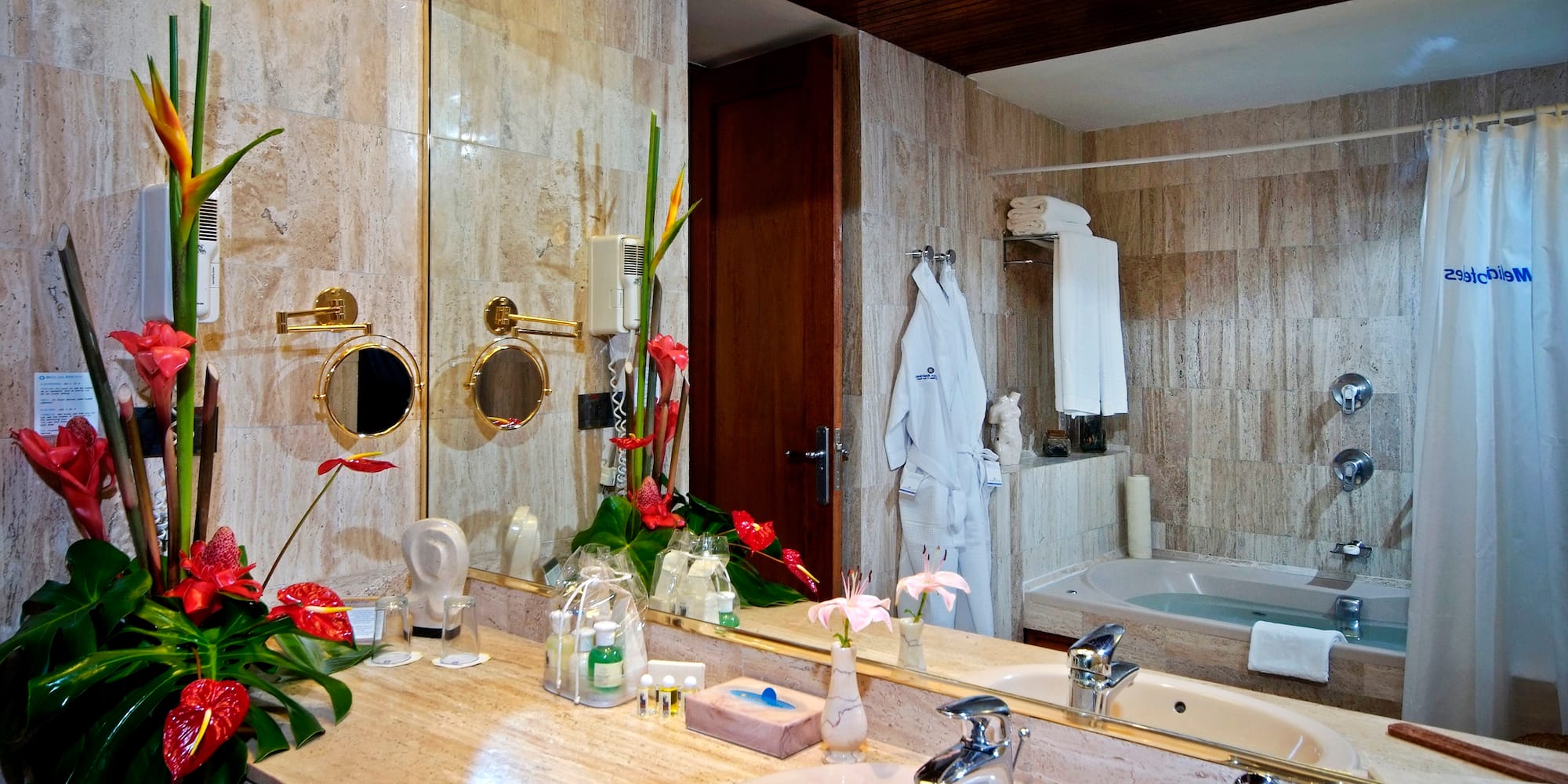 a bathroom with a large mirror and a bathtub