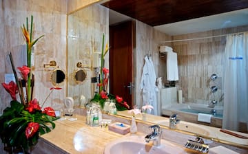 a bathroom with a large mirror and a bathtub