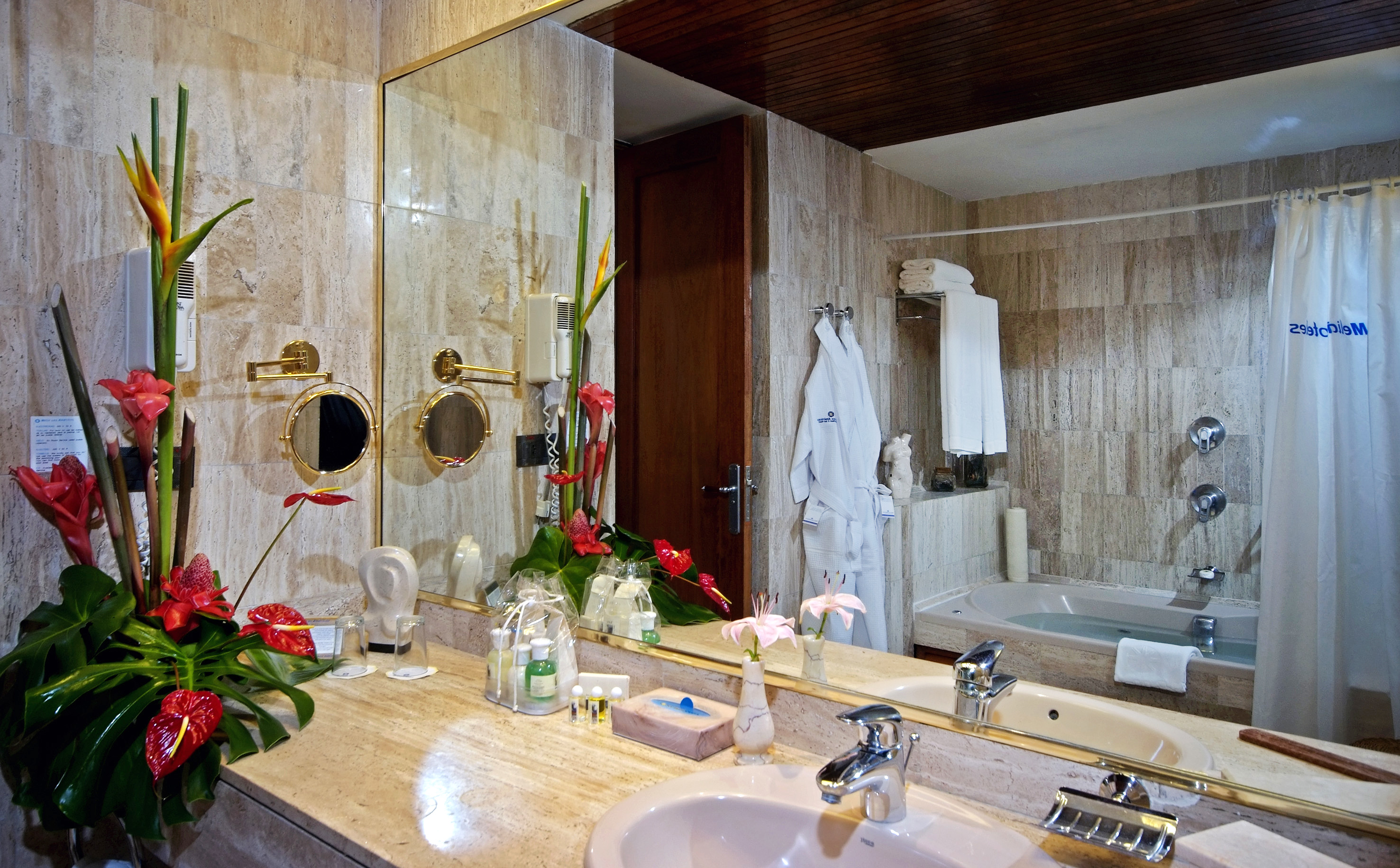 a bathroom with a large mirror and a bathtub