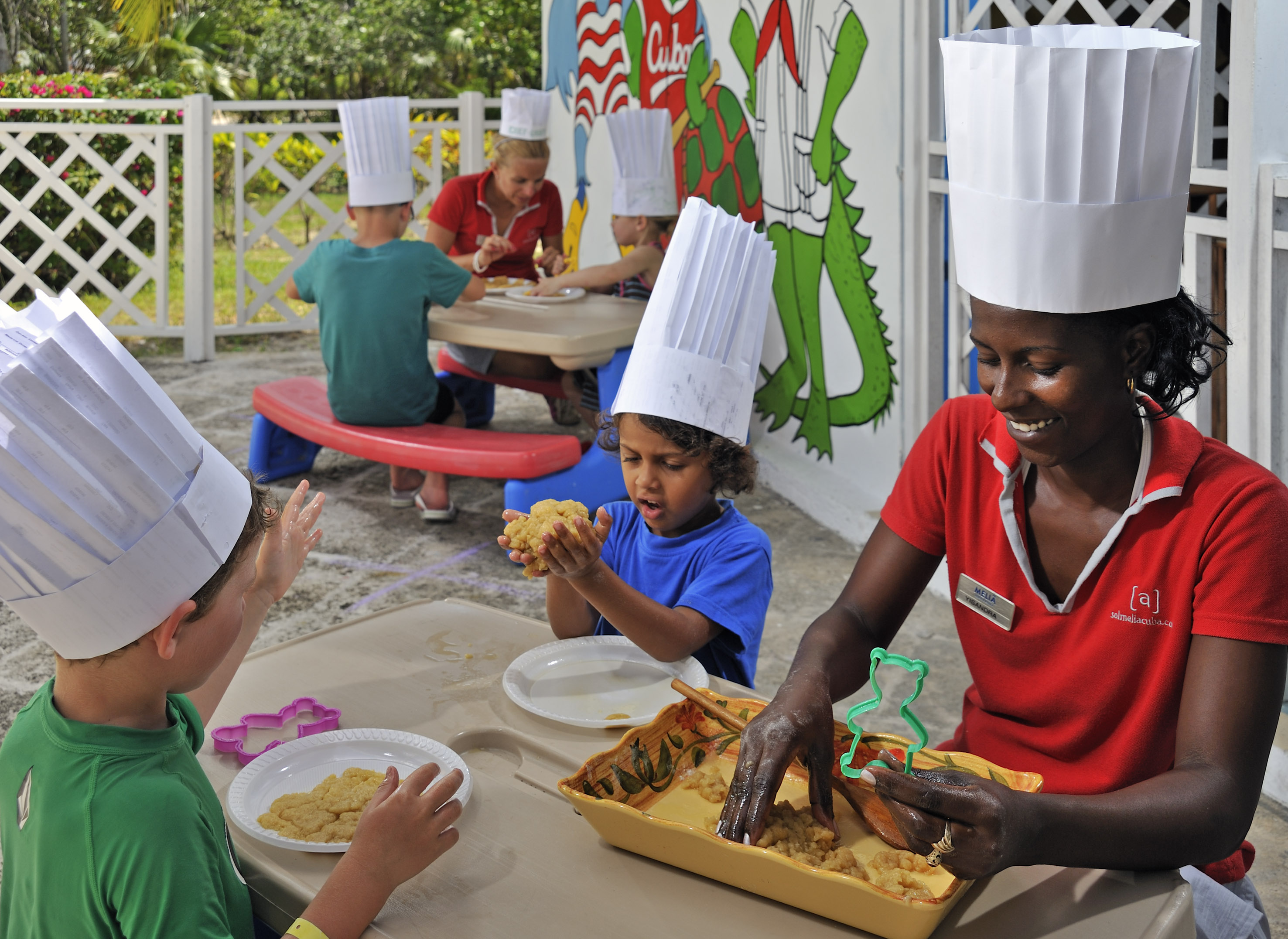 a group of kids eating at a table