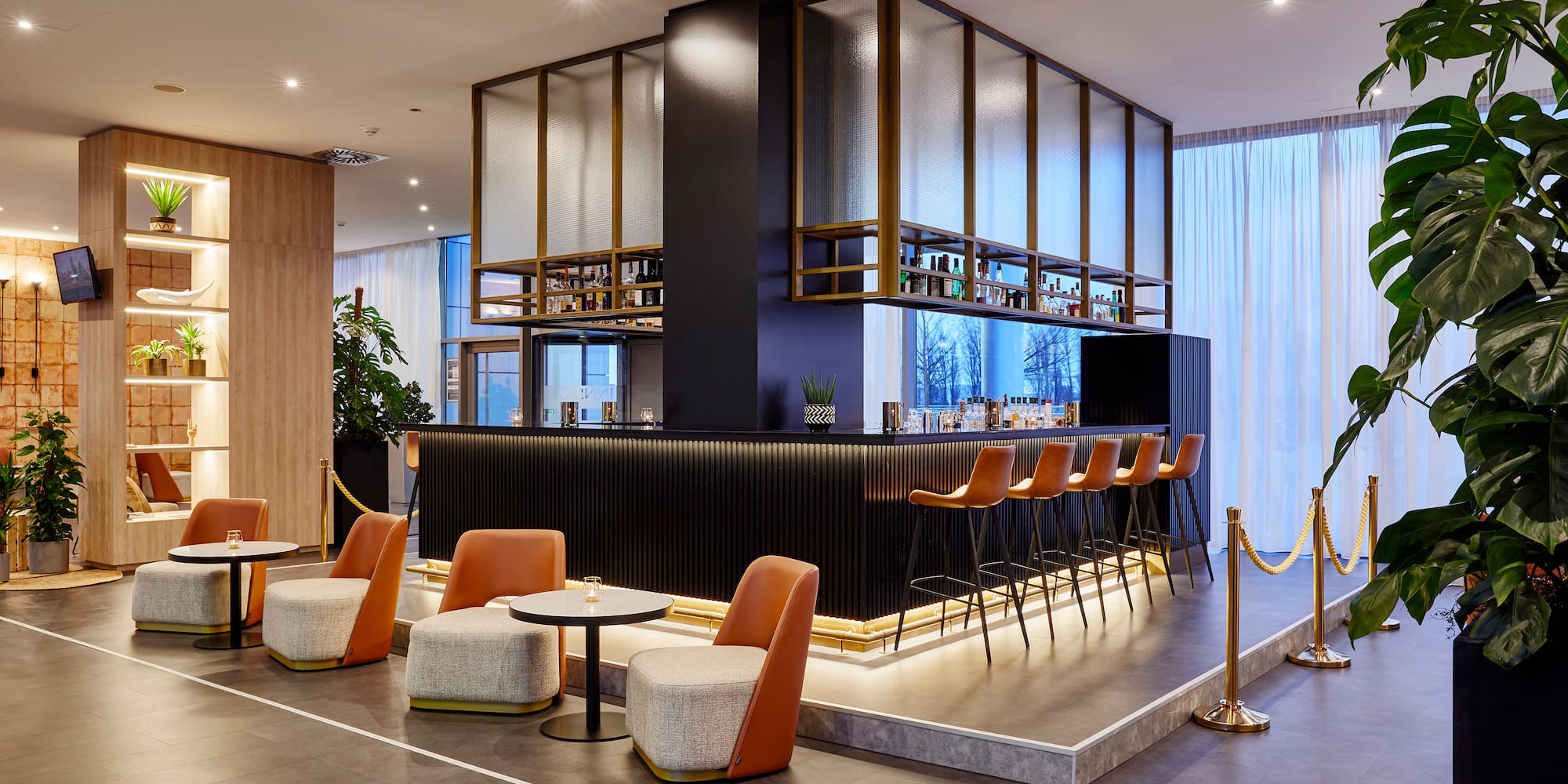 a bar with chairs and a bar in a room