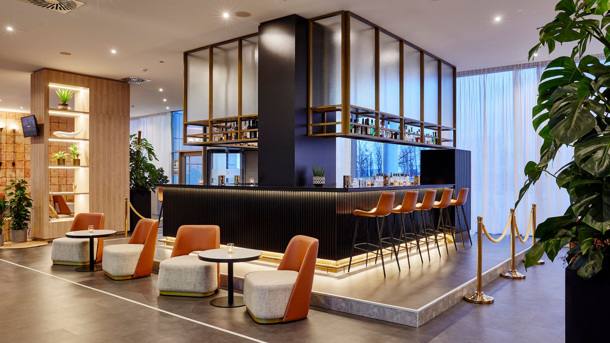 a bar with chairs and a bar in a room