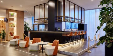 a bar with chairs and a bar in a room