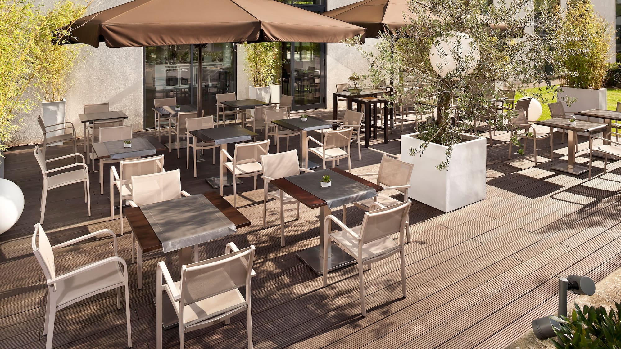 a patio with tables and chairs