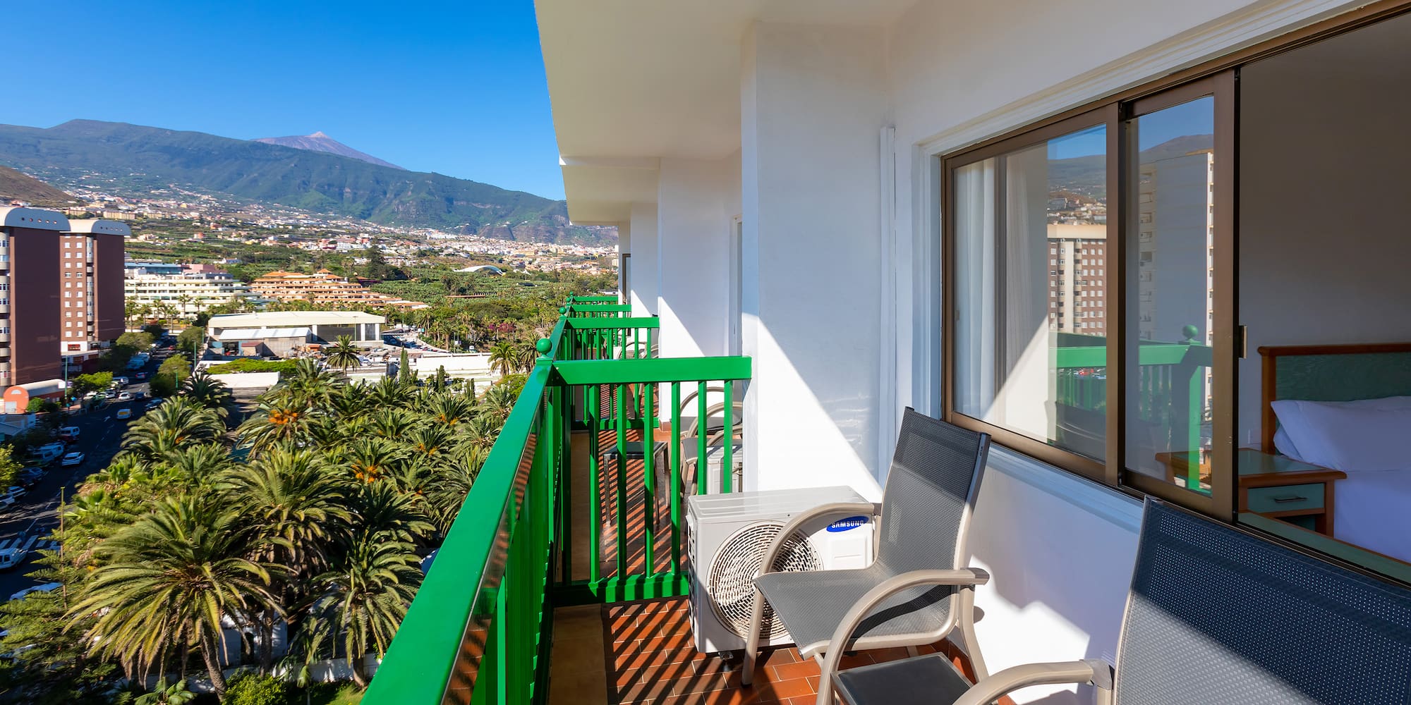 a balcony with chairs and a table and chairs on it