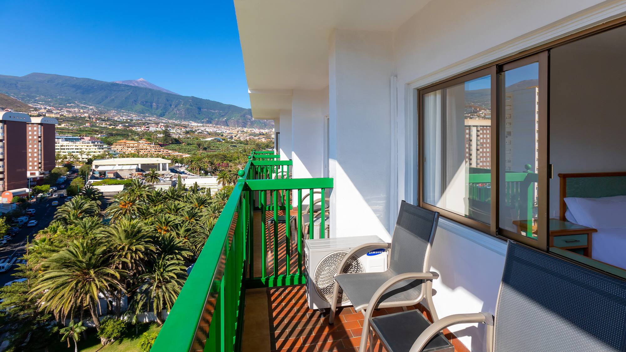 a balcony with chairs and a table and chairs on it