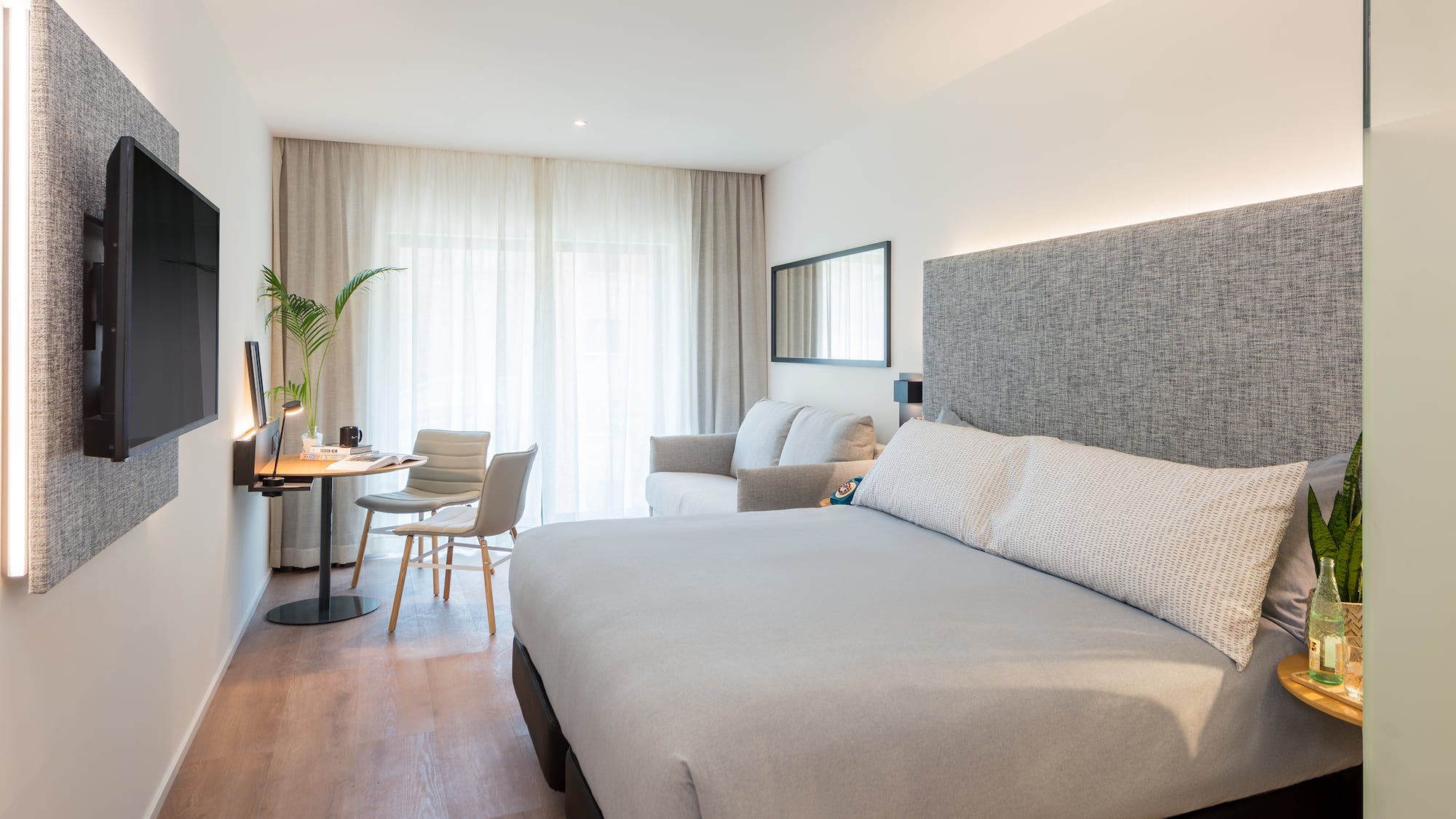 a bedroom with a bed and a desk