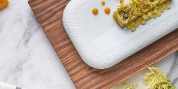 food on a plate next to dried fruits