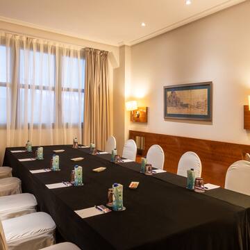 a room with a long table and chairs
