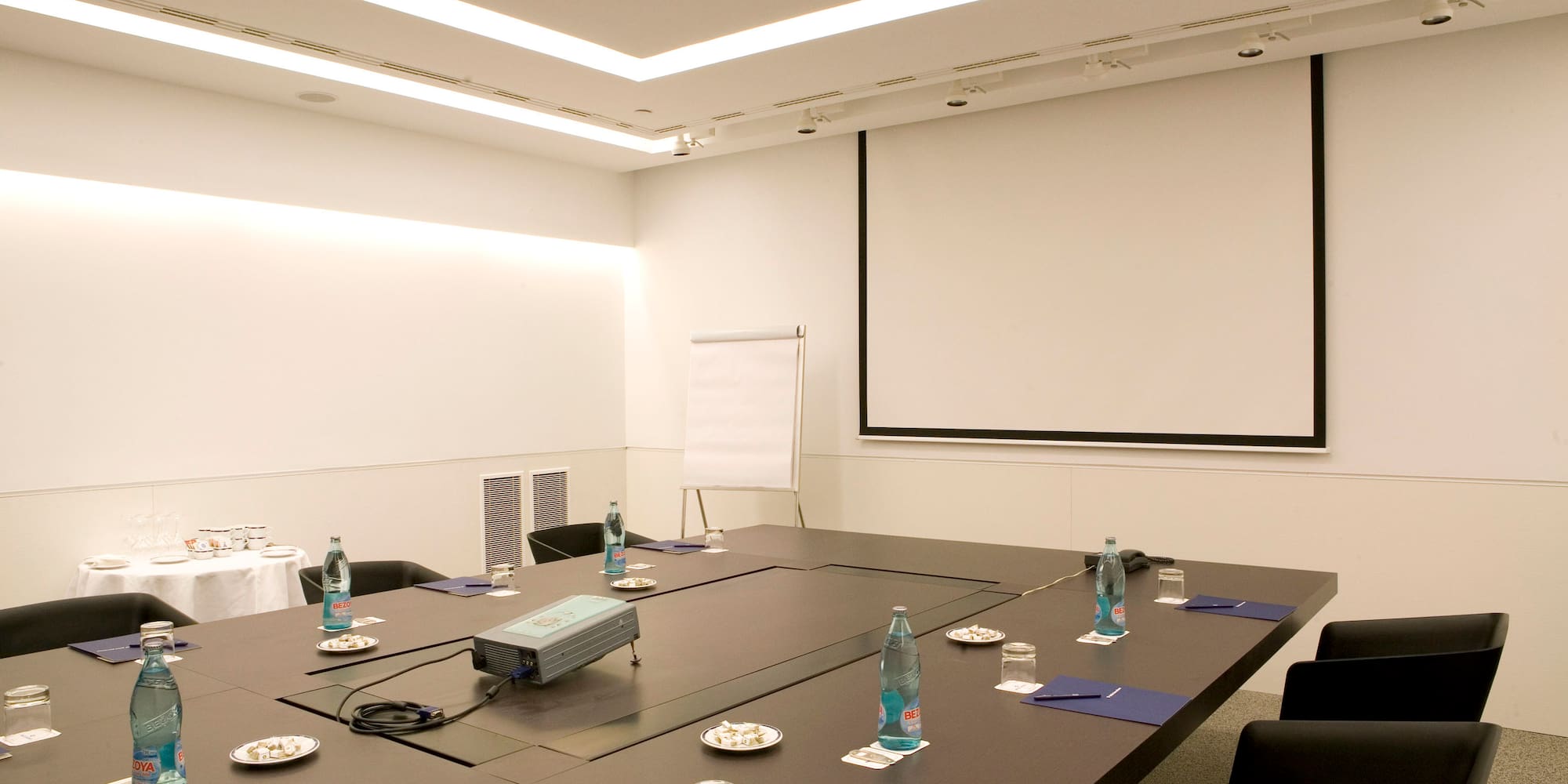 a conference room with a projector screen