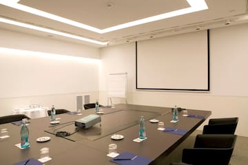a conference room with a projector screen