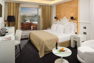 a room with a bed and a table and chairs