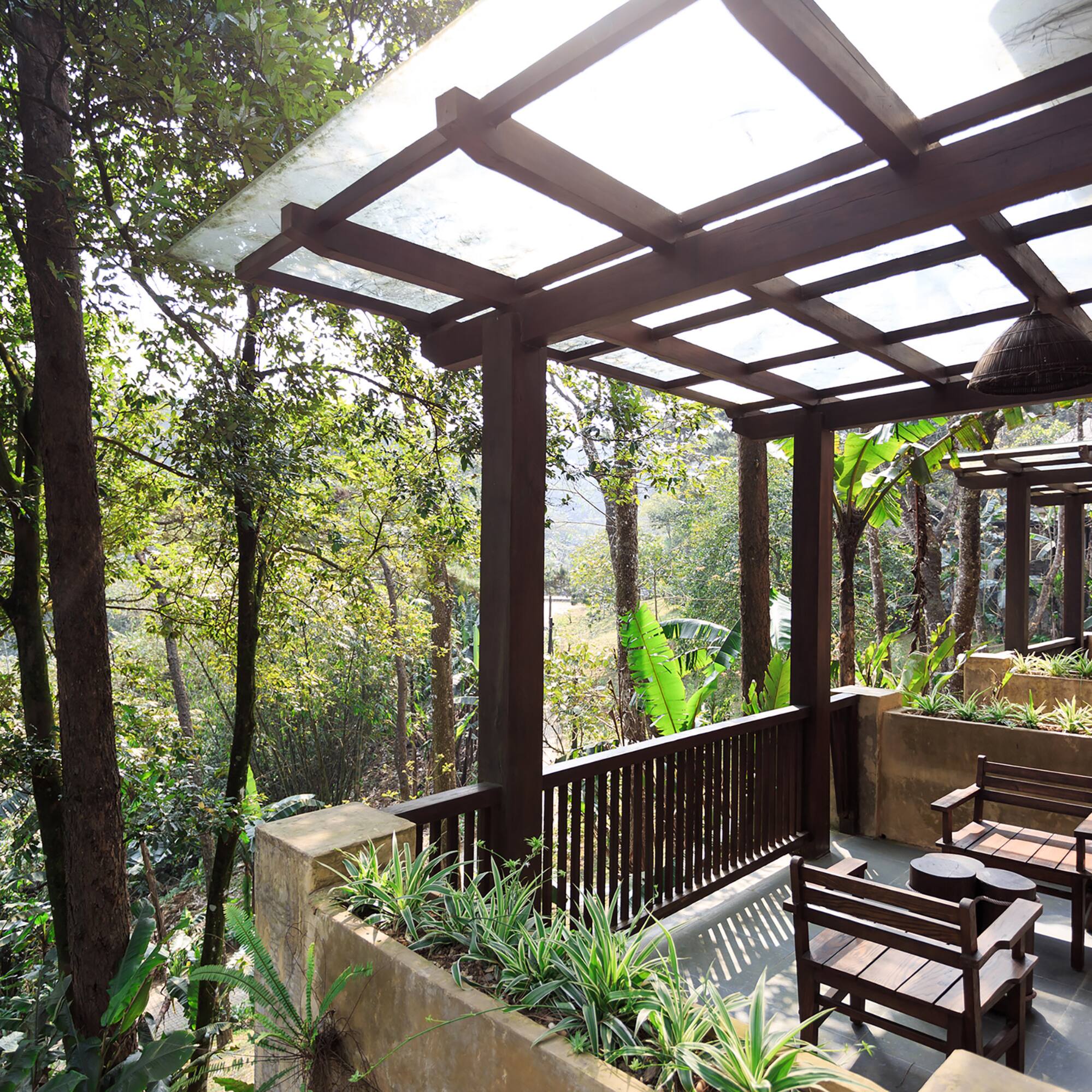 a patio with a covered deck and chairs