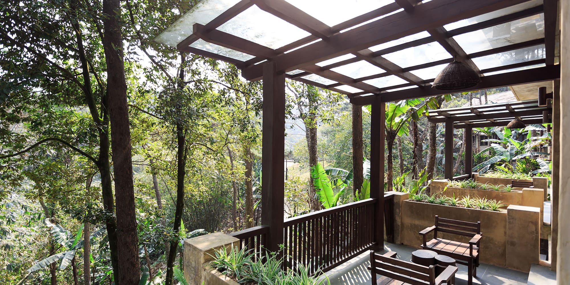 a patio with a covered deck and chairs