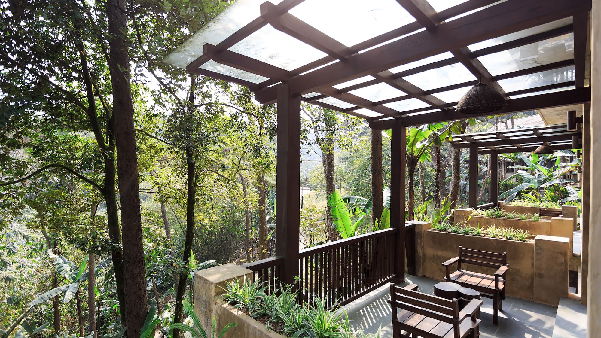 a patio with a covered deck and chairs