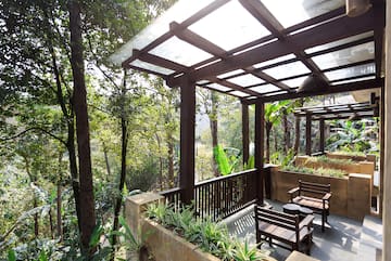 a patio with a covered deck and chairs