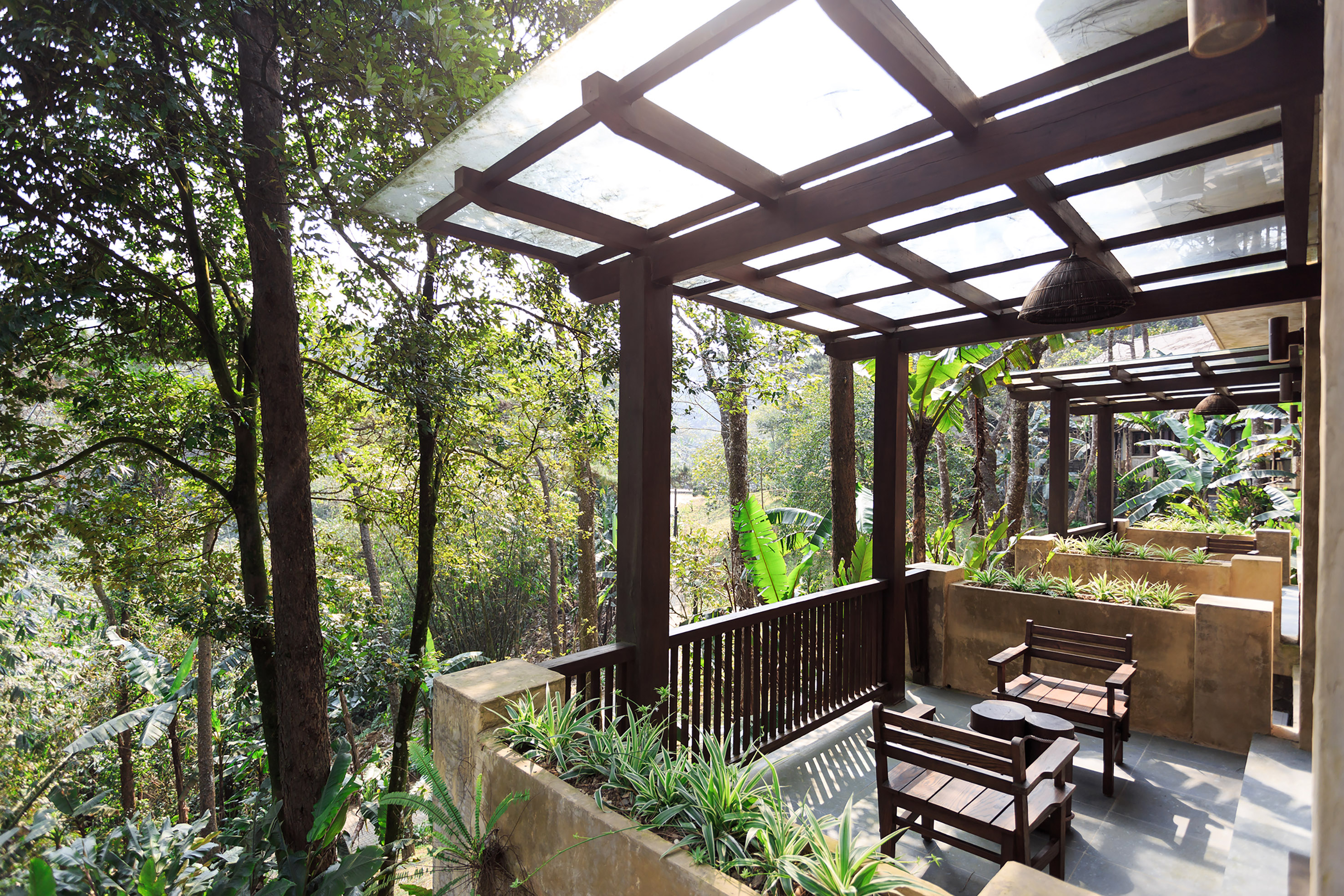 a patio with a covered deck and chairs