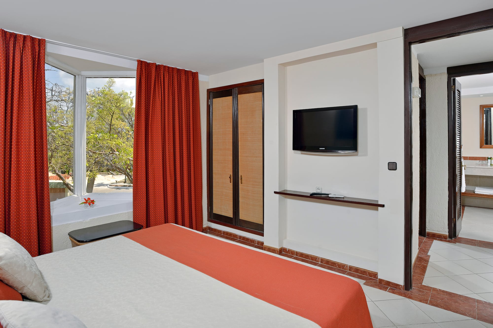 a room with a bed and a television