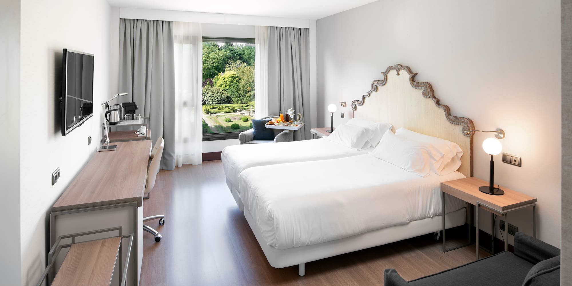 a room with two beds and a desk and a chair