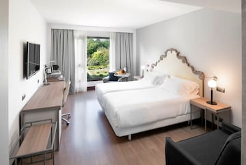 a room with two beds and a desk and a chair