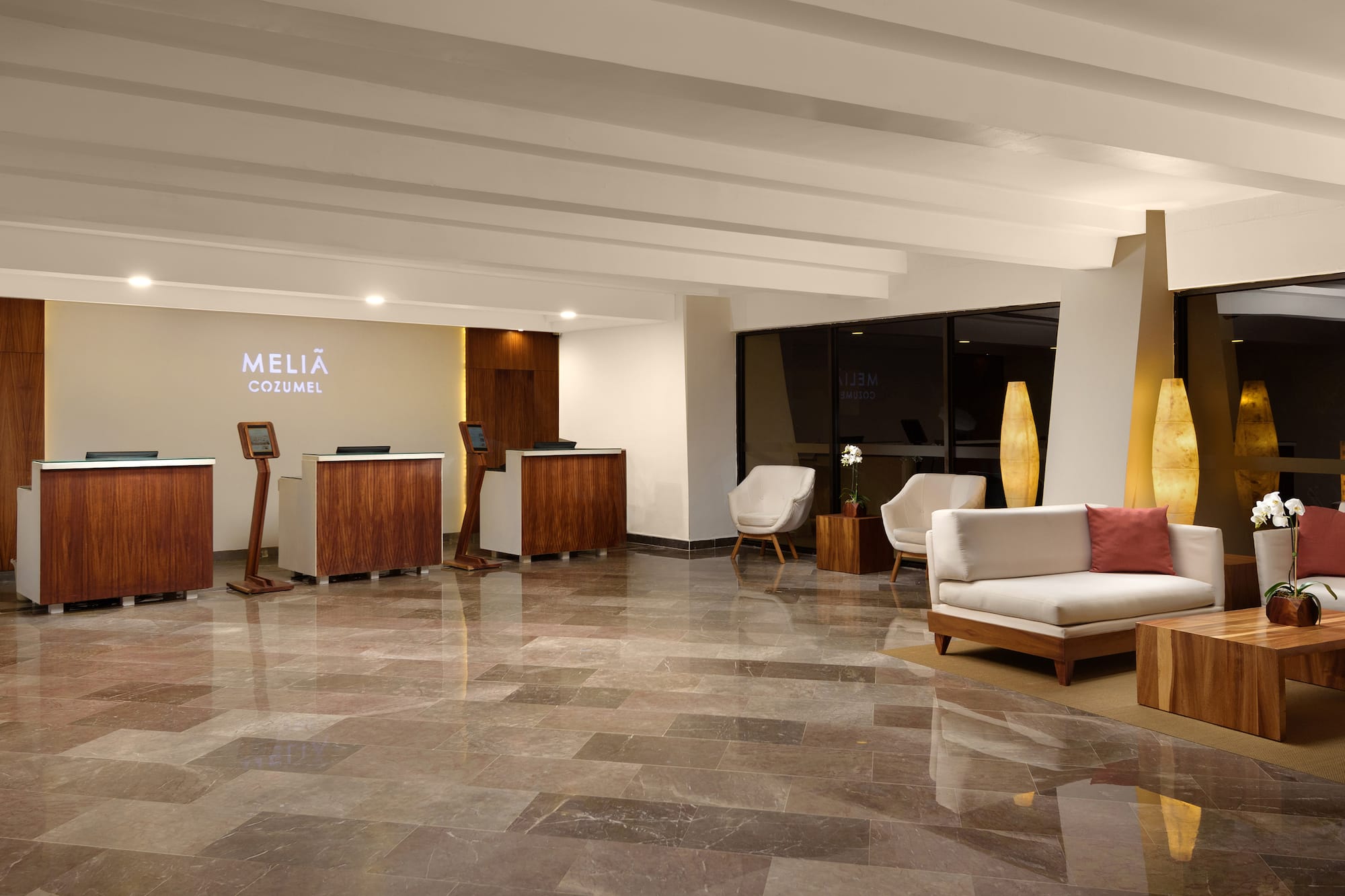 a lobby with a marble floor and a white couch