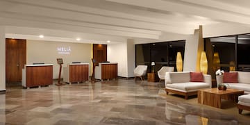 a lobby with a marble floor and a white couch