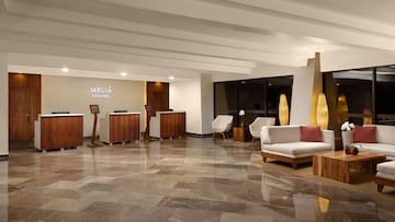 a lobby with a marble floor and a white couch