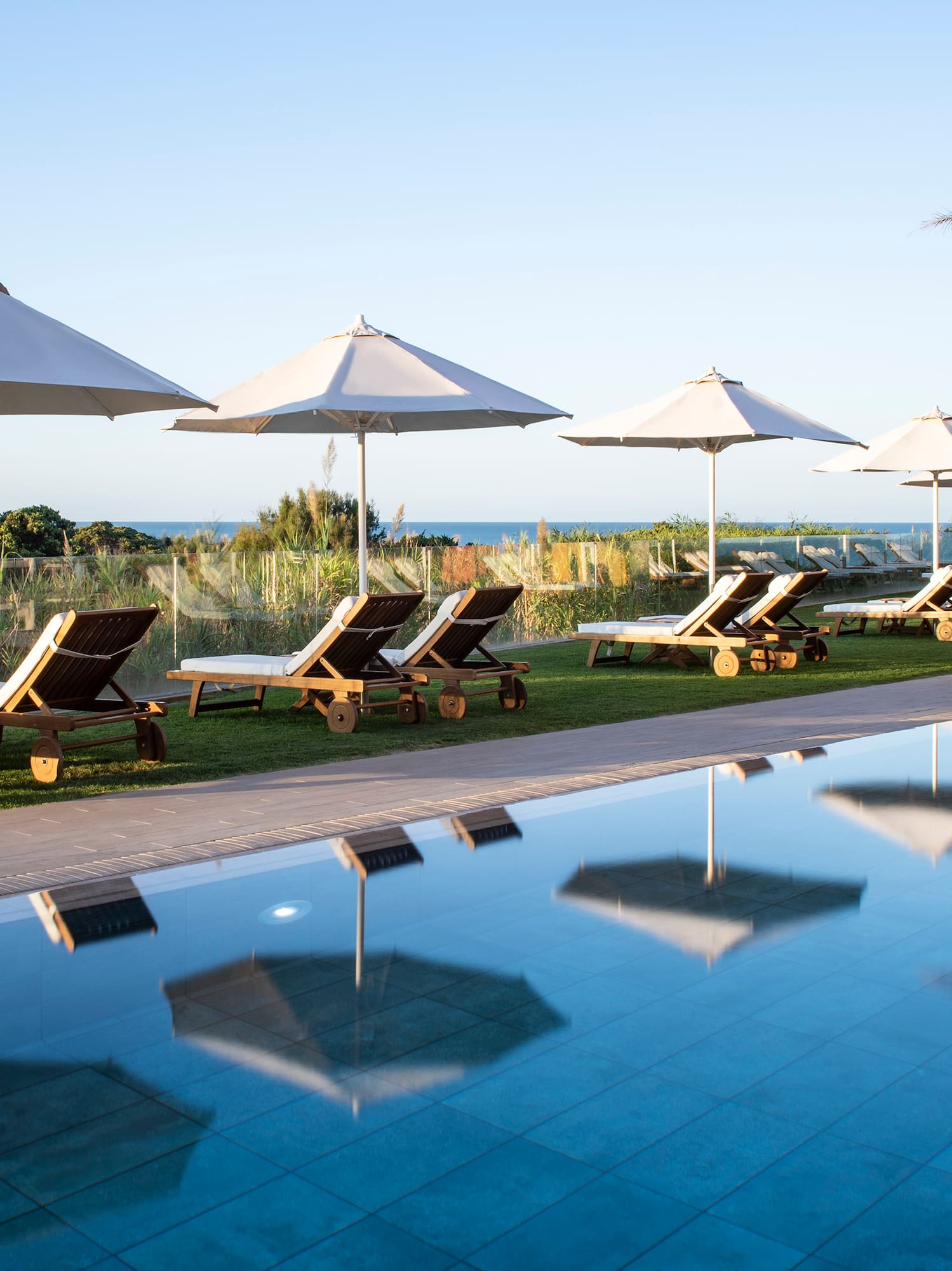 a pool with chairs and umbrellas