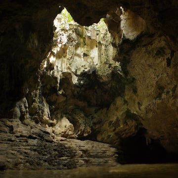 a cave with a hole in the wall