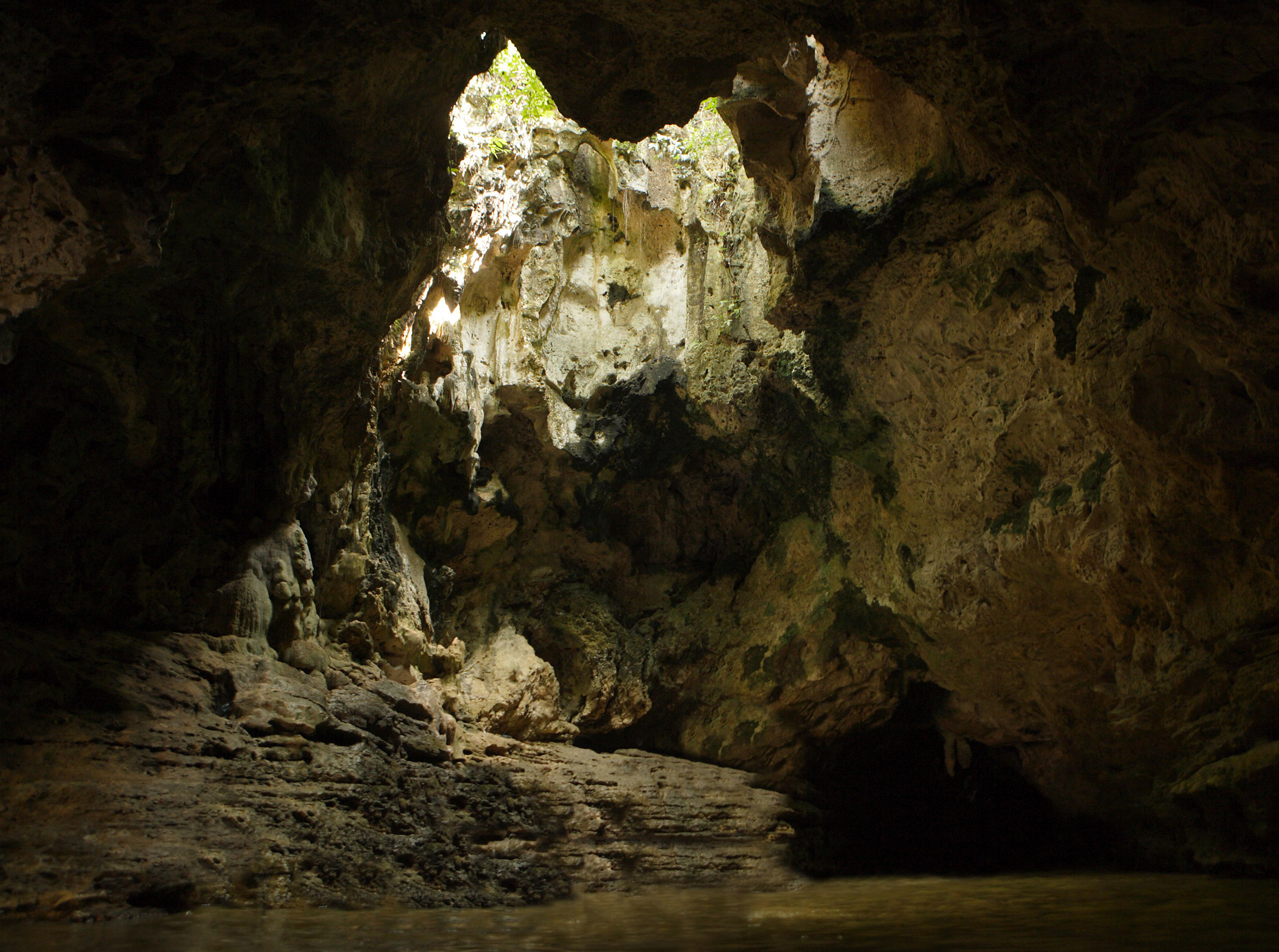 a cave with a hole in the wall