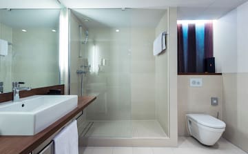 a bathroom with a glass shower and toilet