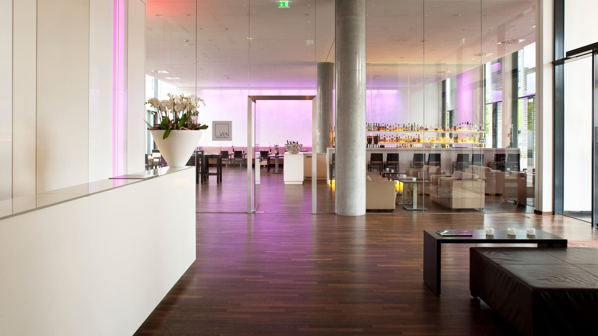 a room with glass walls and a bar