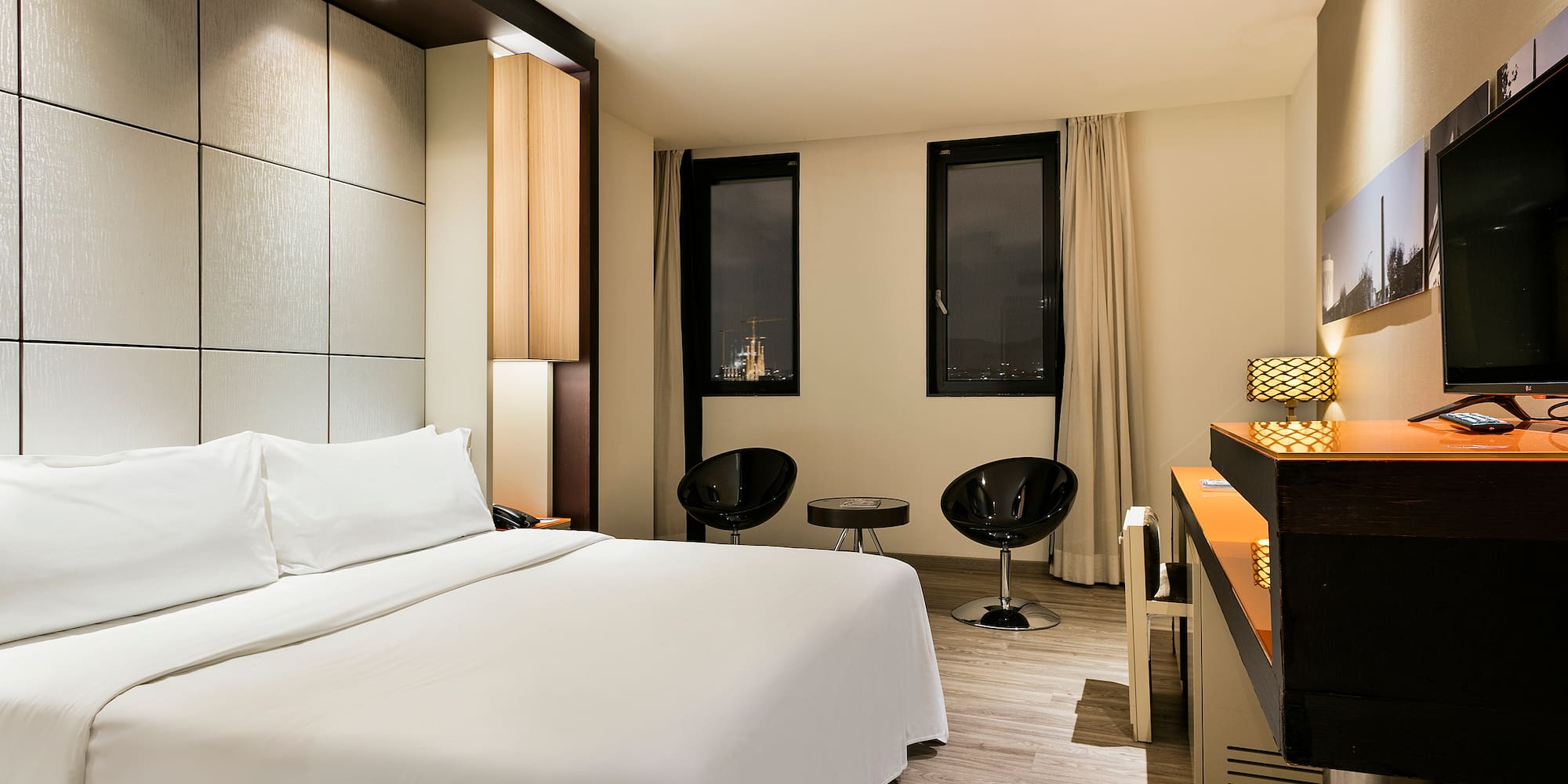 a room with a bed and chairs