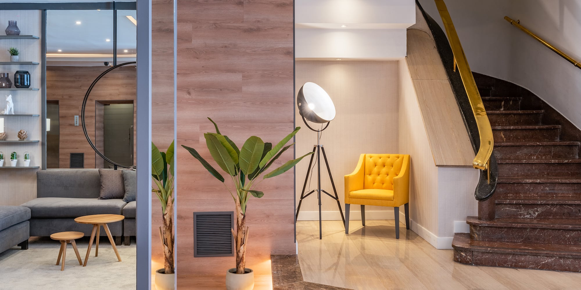 a room with a staircase and a yellow chair