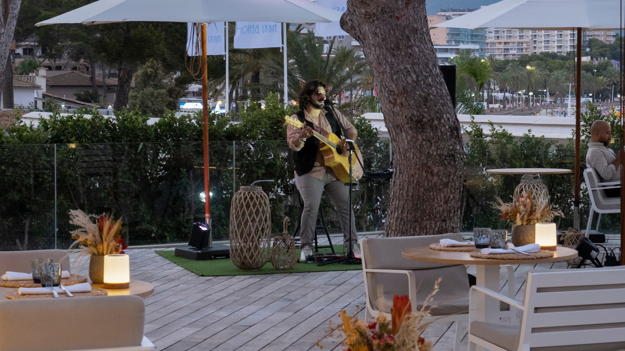 a man playing a guitar on a deck